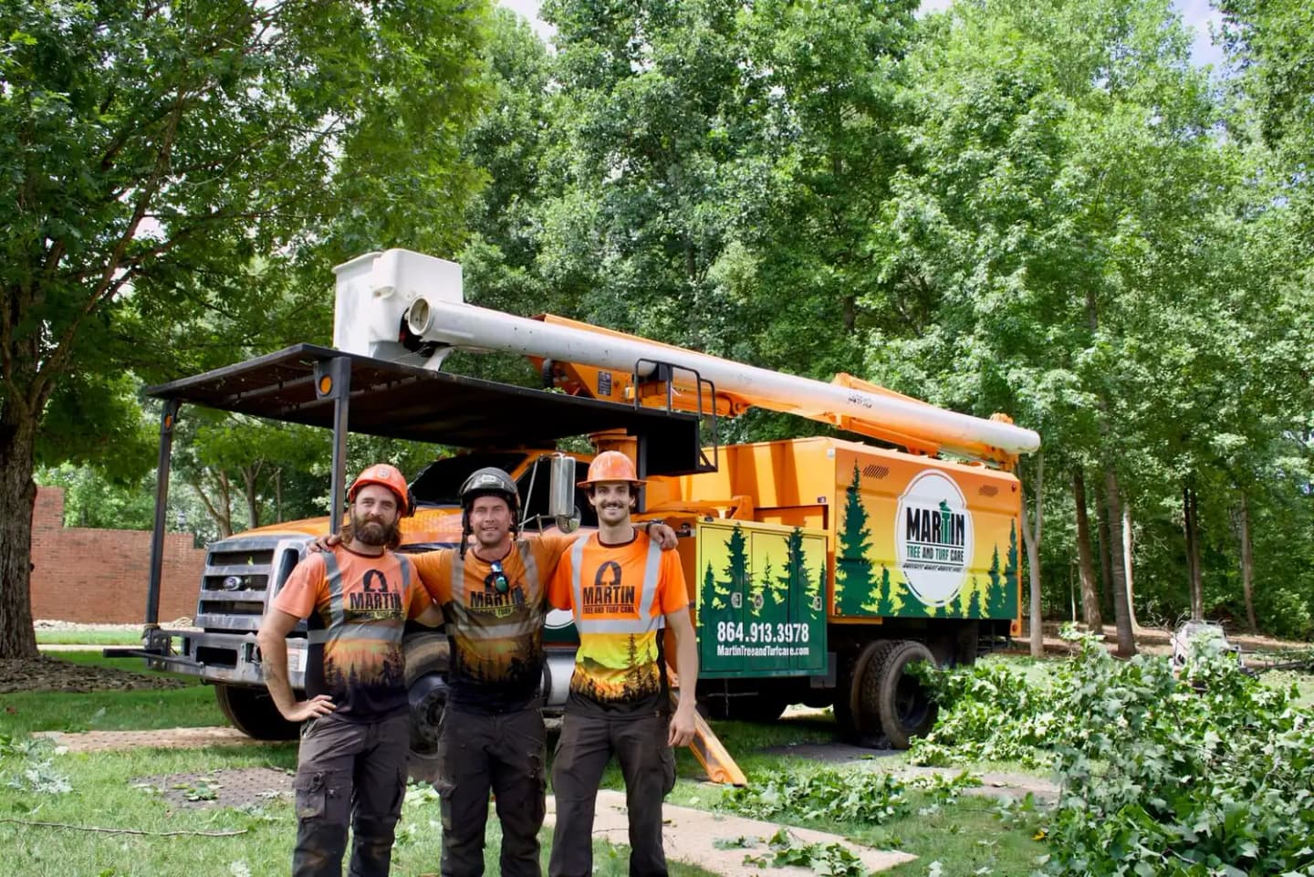 Martin Tree and Turf Care crew in front of their bucket truck at a tree removal job in Upstate SC