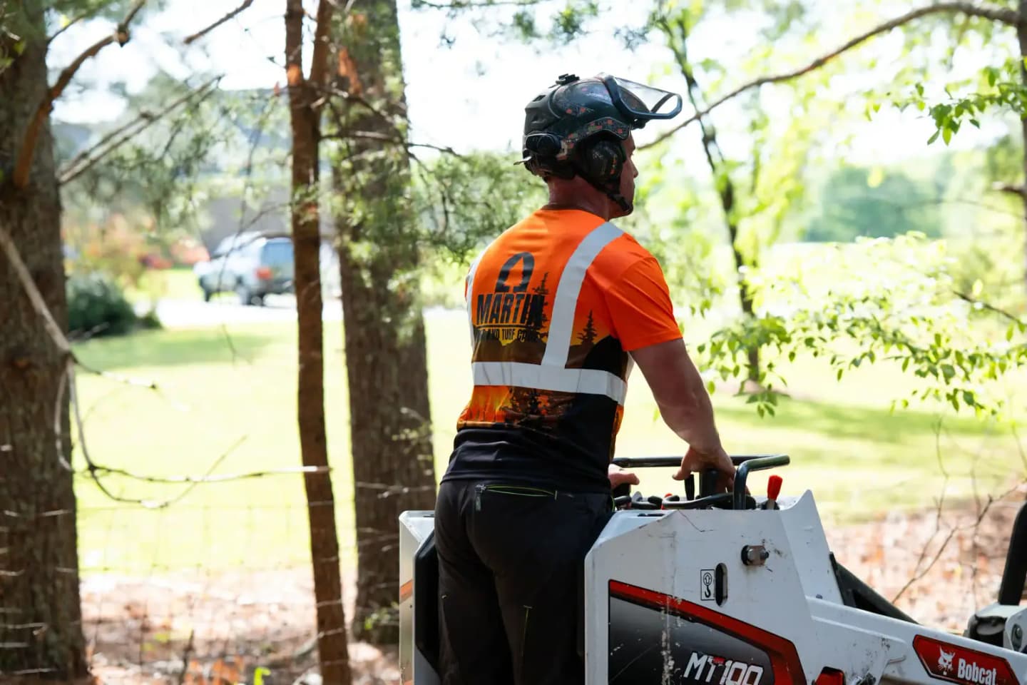 Martin Tree and Turf Care crew working across an open green lawn in Upstate South Carolina
