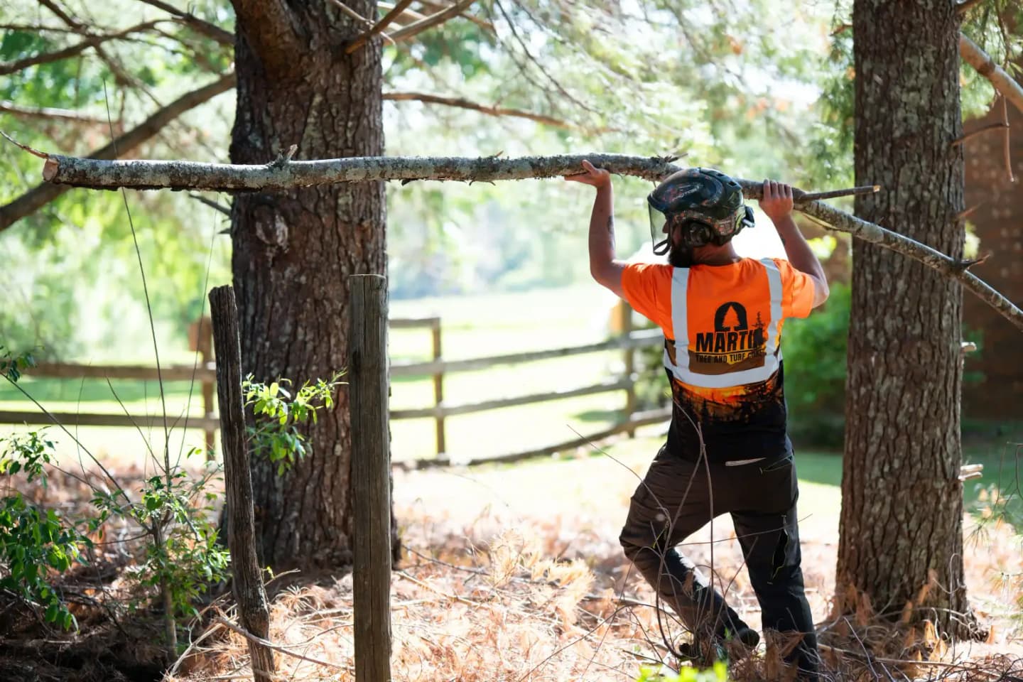 Martin Tree and Turf Care crew member moving a limb on a tree service job in Upstate South Carolina