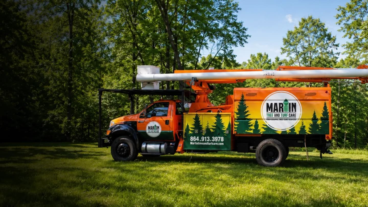 Martin Tree and Turf Care bucket truck on an Upstate SC job site — aerial access for canopy work